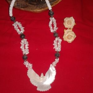 Shell necklace and cuff bracelet with knit top